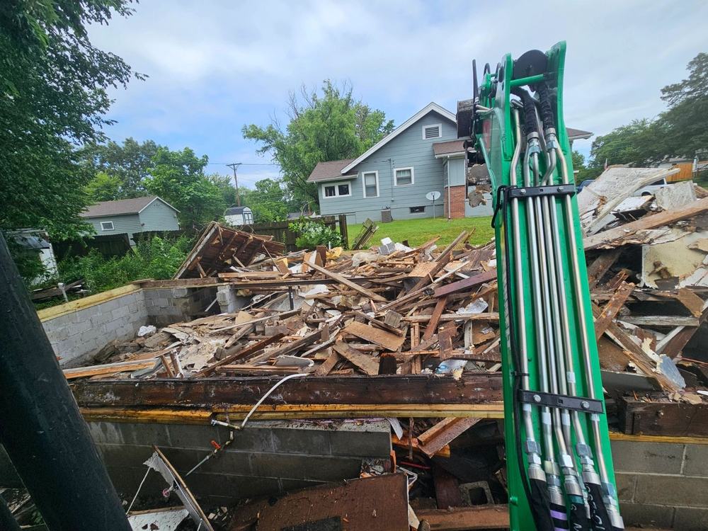 Structure demolition with excavator